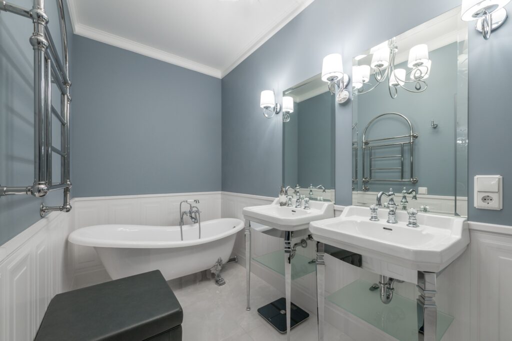 Contemporary bathroom interior featuring a freestanding bathtub and dual sinks with elegant lighting.